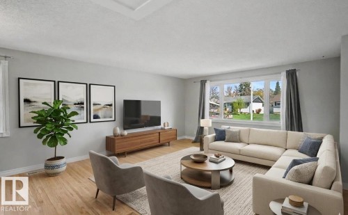 Spacious living area featuring light wood-finish flooring, a large multi-pane window, and light-toned wall finishes - 16715 79A Avenue, Edmonton, AB - Indoor Photo Showing Living Room