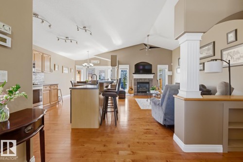 Open-concept living space with wood-finish flooring, a vaulted ceiling, and recessed lighting - 9 Danfield Place, Spruce Grove, AB - Indoor With Fireplace