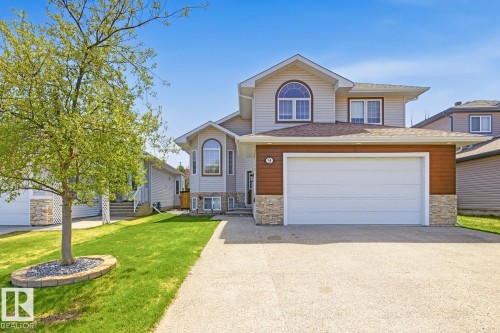 Two-story property featuring light gray siding with stone veneer accents - 9 Danfield Place, Spruce Grove, AB - Outdoor With Facade