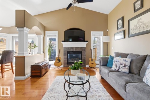 Living area featuring a vaulted ceiling and a ceiling fan - 9 Danfield Place, Spruce Grove, AB - Indoor Photo Showing Living Room With Fireplace