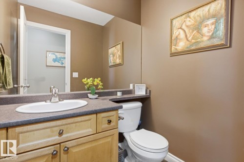 Bathroom vanity with a light wood-finish base cabinetry, an oval undermount sink, and a gray countertop - 9 Danfield Place, Spruce Grove, AB - Indoor Photo Showing Bathroom