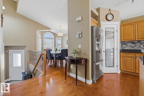 Hardwood-finish flooring extending into the kitchen, dining, and entry areas - 9 Danfield Place, Spruce Grove, AB - Indoor