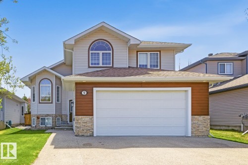Two-story residence featuring light-colored siding and a two-car garage - 9 Danfield Place, Spruce Grove, AB - Outdoor