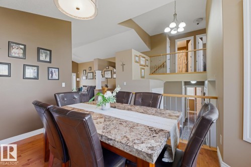 Open-concept interior featuring wood-finish flooring, a multi-level layout, and neutral wall tones - 9 Danfield Place, Spruce Grove, AB - Indoor Photo Showing Dining Room