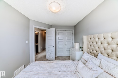Carpeted room with light grey walls and a textured ceiling - 6919 Cardinal Wynd, Edmonton, AB - Indoor Photo Showing Bedroom