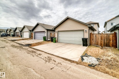 Rear-facing garage with concrete driveway - 6919 Cardinal Wynd, Edmonton, AB - Outdoor