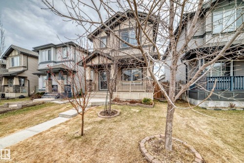 Craftsman-style exterior featuring a stone accent façade and a covered front porch - 6919 Cardinal Wynd, Edmonton, AB - Outdoor With Deck Patio Veranda With Facade
