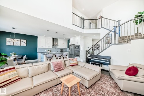 Expansive living area featuring high ceilings and dark wood-finish flooring - 3716 46 Avenue, Beaumont, AB - Indoor Photo Showing Living Room