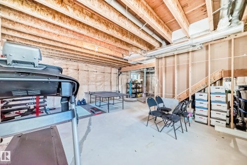 Unfinished basement featuring exposed wood joists, framed wall sections, and concrete flooring - 3716 46 Avenue, Beaumont, AB - Indoor Photo Showing Basement