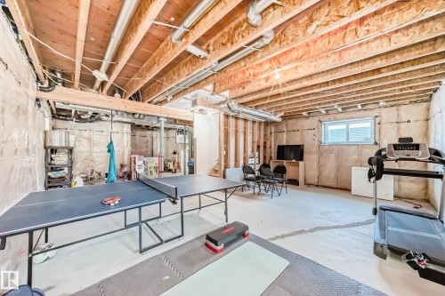 Unfinished basement featuring exposed wood joists and concrete flooring - 3716 46 Avenue, Beaumont, AB - Indoor Photo Showing Basement