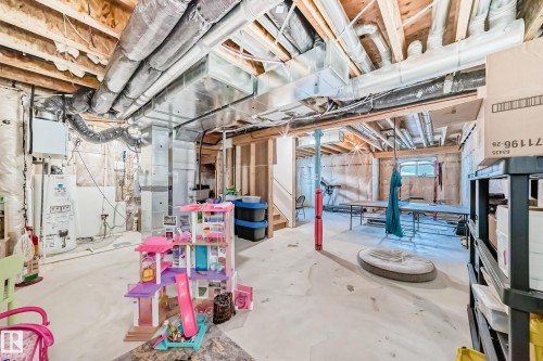 Unfinished basement featuring exposed wood joists, ductwork, and structural elements - 3716 46 Avenue, Beaumont, AB - Indoor Photo Showing Basement