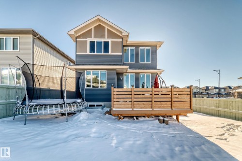 Rear exterior featuring dark gray siding and a light gray gable accent - 3716 46 Avenue, Beaumont, AB - Outdoor