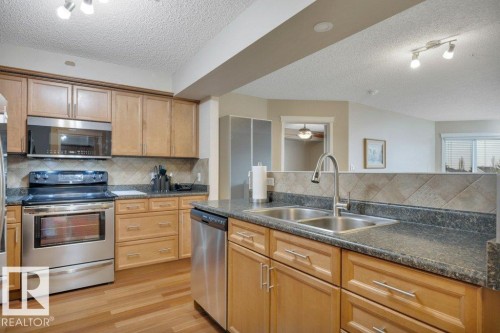 302 102A Bridgeport Crossing, Leduc, AB - Indoor Photo Showing Kitchen With Double Sink