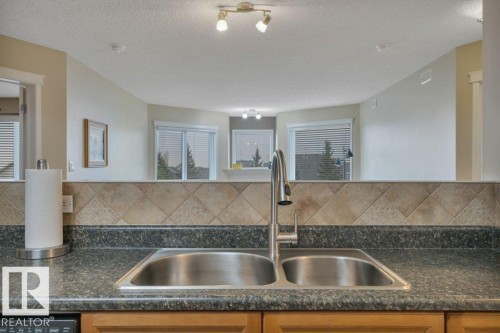 302 102A Bridgeport Crossing, Leduc, AB - Indoor Photo Showing Kitchen With Double Sink