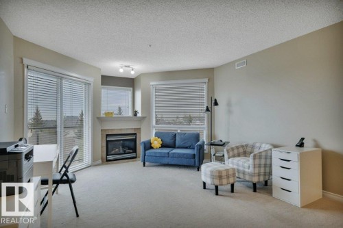 302 102A Bridgeport Crossing, Leduc, AB - Indoor Photo Showing Living Room With Fireplace