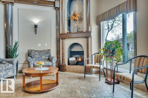 302 102A Bridgeport Crossing, Leduc, AB - Indoor Photo Showing Living Room With Fireplace