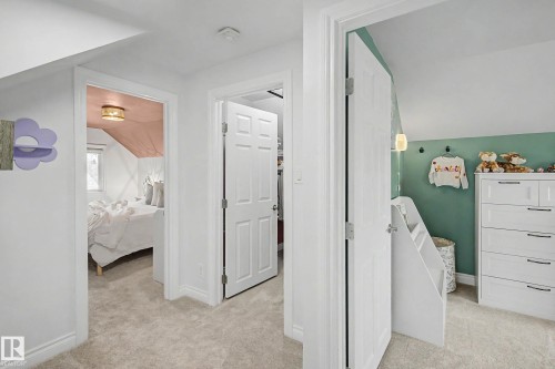Carpeted hallway providing access to three distinct spaces - 13316 109A Avenue, Edmonton, AB - Indoor