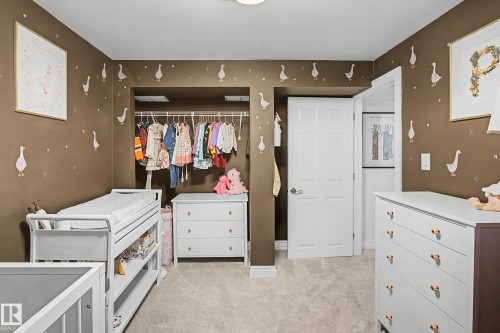 Recessed closet with integrated shelving and hanging rods - 13316 109A Avenue, Edmonton, AB - Indoor