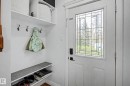 White entry door featuring leaded glass paneling with a smart lock system - 13316 109A Avenue, Edmonton, AB  - Indoor Photo Showing Other Room 