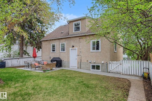 Expansive backyard featuring a manicured lawn, a concrete patio, and a privacy fence - 13316 109A Avenue, Edmonton, AB - Outdoor With Exterior