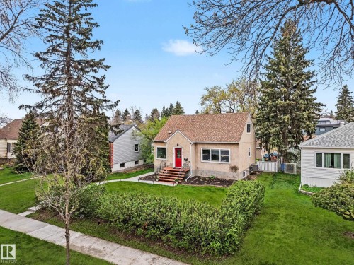 Gable-roof property featuring a textured exterior and a prominent red entry door - 13316 109A Avenue, Edmonton, AB - Outdoor