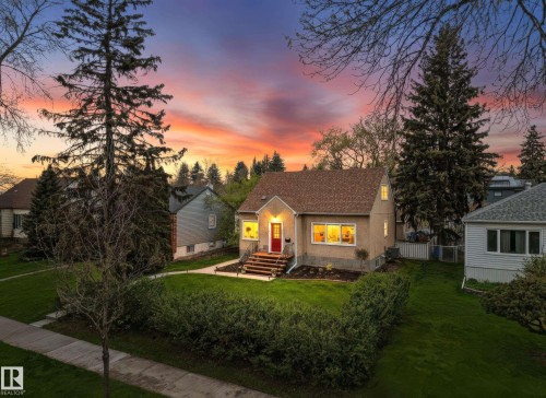 Single-family residence featuring a red entry door, an asphalt shingle roof, and a low-maintenance stucco exterior - 13316 109A Avenue, Edmonton, AB - Outdoor