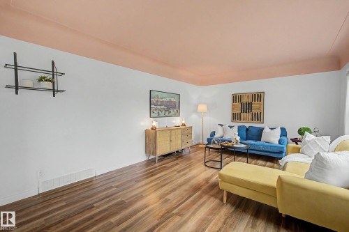 Living space featuring wood-finish flooring, white walls, and a painted ceiling - 13316 109A Avenue, Edmonton, AB - Indoor Photo Showing Living Room