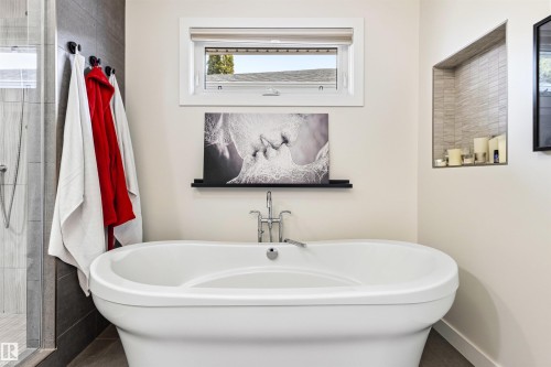 Freestanding soaking tub with chrome fixtures - 14608 97 Avenue, Edmonton, AB - Indoor Photo Showing Bathroom