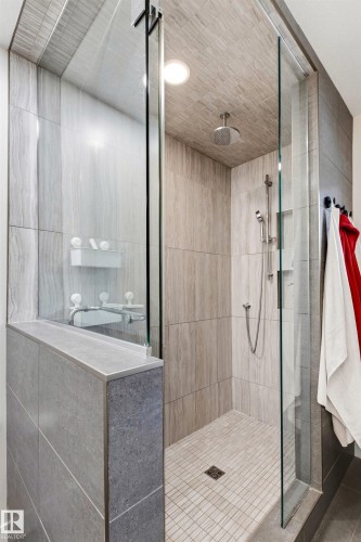 Walk-in shower with full glass enclosure and a ceiling-mounted rain shower head - 14608 97 Avenue, Edmonton, AB - Indoor Photo Showing Bathroom