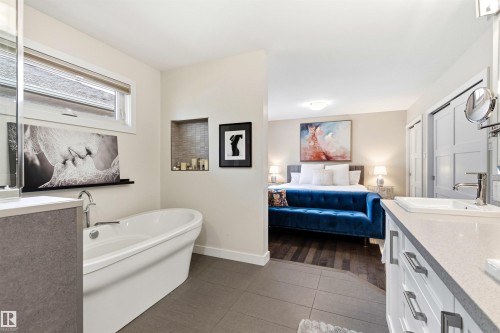 Bathroom featuring a freestanding soaking tub, a built-in recessed tiled shelf, and a vanity with a rectangular undermount sink - 14608 97 Avenue, Edmonton, AB - Indoor Photo Showing Bathroom
