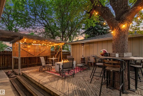 Multi-level wood deck featuring a built-in pergola with string lighting - 14608 97 Avenue, Edmonton, AB - Outdoor With Deck Patio Veranda