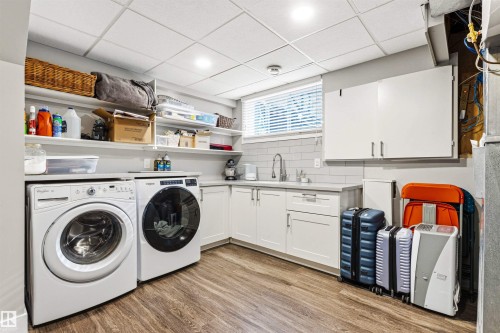 Laundry area featuring wood-finish flooring and a drop ceiling - 14608 97 Avenue, Edmonton, AB - Indoor Photo Showing Laundry Room