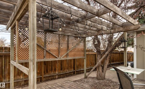 Wood pergola structure with string lighting and lattice privacy screens - 14608 97 Avenue, Edmonton, AB - Outdoor With Deck Patio Veranda