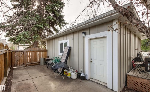 Utility building with vertical siding and a single panel door - 14608 97 Avenue, Edmonton, AB - Outdoor With Exterior