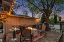 Expansive wood deck with string lighting and a built-in fire pit - 14608 97 Avenue, Edmonton, AB  - Outdoor With Deck Patio Veranda 