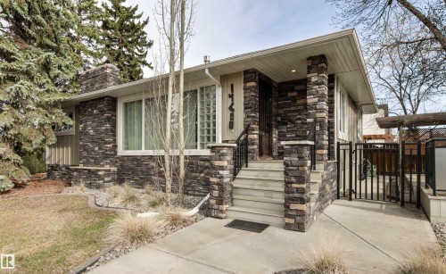 Stone veneer facade with prominent stone columns and chimney - 14608 97 Avenue, Edmonton, AB - Outdoor