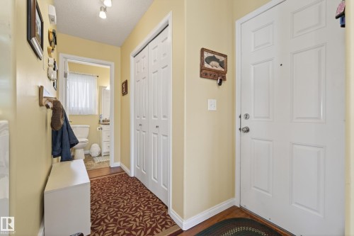 Entryway featuring a white paneled door, light yellow walls, and track lighting - 77 Lakeshore Drive, Rural Leduc County, AB - Indoor Photo Showing Other Room