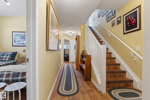 Hallway featuring wood-finish flooring and light yellow walls - 77 Lakeshore Drive, Rural Leduc County, AB - Indoor Photo Showing Other Room