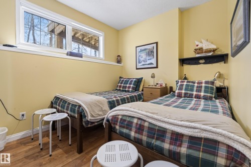 Room with wood-finish flooring and light yellow walls - 77 Lakeshore Drive, Rural Leduc County, AB - Indoor Photo Showing Bedroom