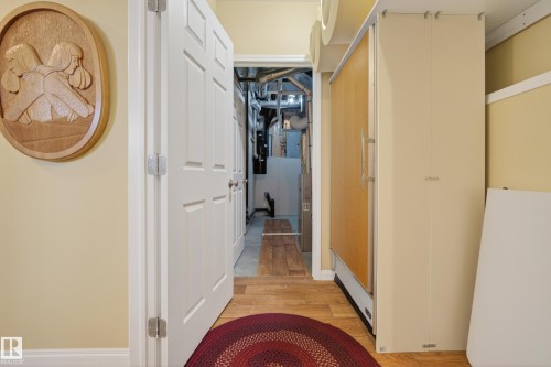 Interior space featuring light yellow wall paint, white baseboards, and wood-finish flooring - 77 Lakeshore Drive, Rural Leduc County, AB - Indoor Photo Showing Other Room