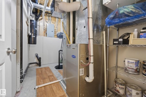 Utility room featuring a central HVAC system, exposed ductwork, water heater, and a sump pump system - 77 Lakeshore Drive, Rural Leduc County, AB - Indoor Photo Showing Basement
