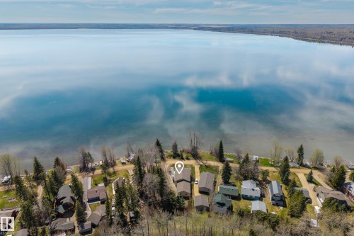 Waterfront property featuring a large lake and surrounding wooded areas - 77 Lakeshore Drive, Rural Leduc County, AB - Outdoor With Body Of Water With View