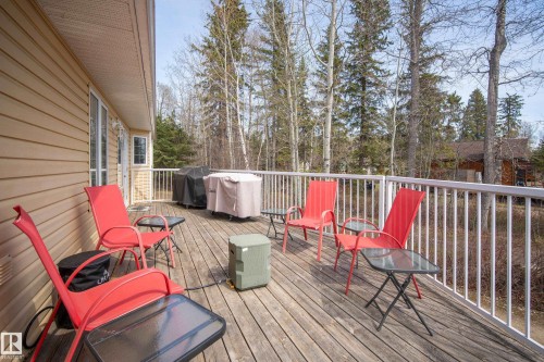 Spacious outdoor deck featuring natural wood flooring and white railing - 77 Lakeshore Drive, Rural Leduc County, AB - Outdoor With Deck Patio Veranda With Exterior