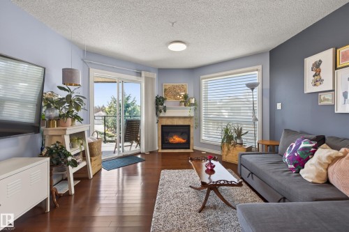 406 7839 96 Street, Edmonton, AB - Indoor Photo Showing Living Room With Fireplace