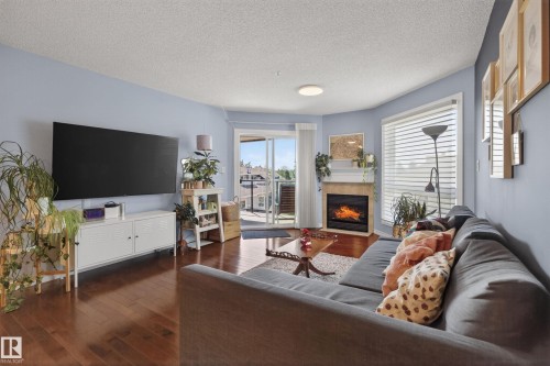 406 7839 96 Street, Edmonton, AB - Indoor Photo Showing Living Room With Fireplace