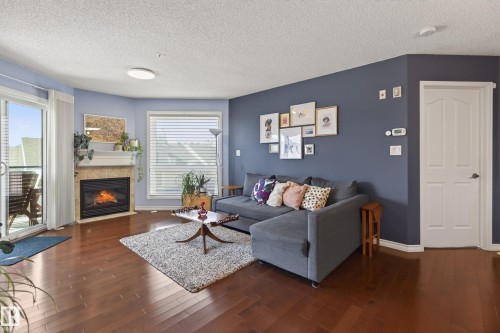 406 7839 96 Street, Edmonton, AB - Indoor Photo Showing Living Room With Fireplace