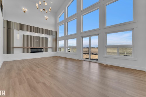 Soaring ceiling with a modern chandelier and recessed lighting - 13128 187 Avenue, Edmonton, AB - Indoor With Fireplace