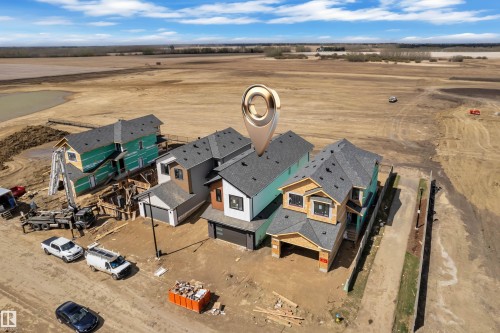 Newly constructed residences featuring modern architectural design with attached garages and shingled roofs - 13128 187 Avenue, Edmonton, AB - Outdoor With View