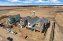 Newly constructed residences featuring modern architectural design with attached garages and shingled roofs - 13128 187 Avenue, Edmonton, AB  - Outdoor With View 