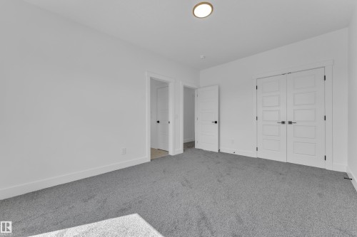 Spacious room featuring gray carpet flooring, white walls, and white trim - 13128 187 Avenue, Edmonton, AB - Indoor Photo Showing Other Room